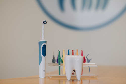 A tooth brush and other dental items sitting on the reception desk at Roscam Family Dental Practice