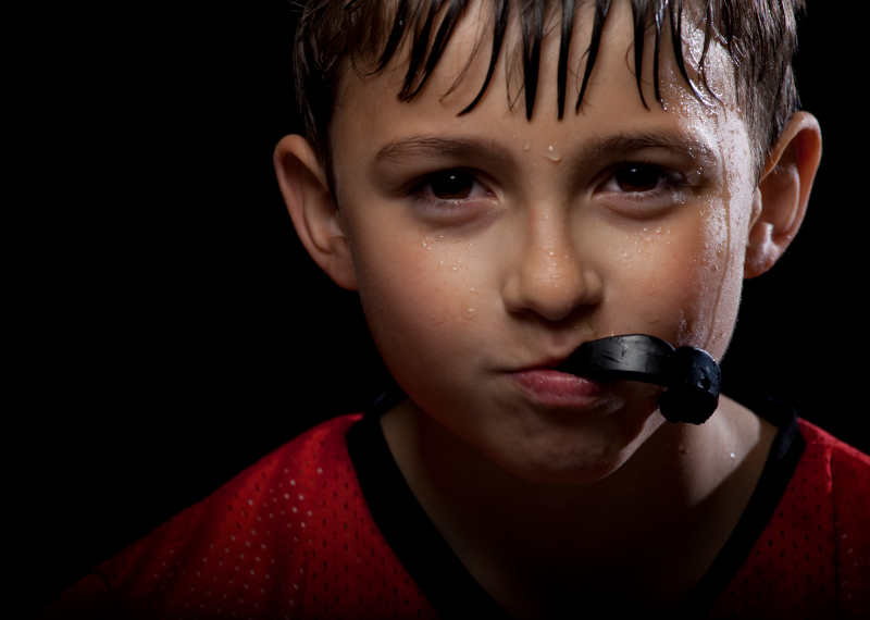 Young boy with a sports guard in his mouth